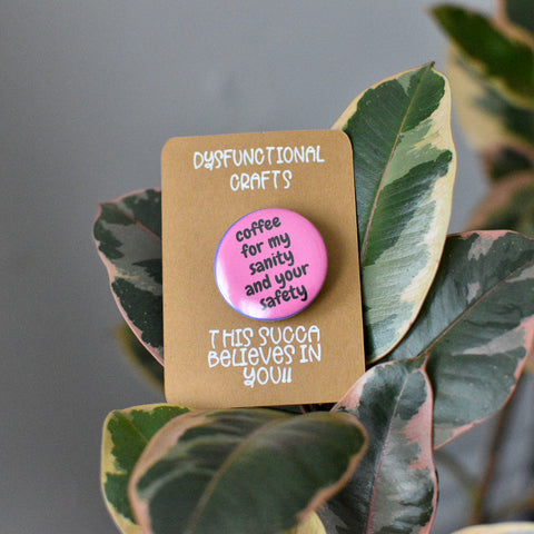 button badge reads coffee for my sanity snd your safety- pink background with black writing