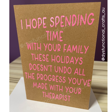 On a kraft brown background reads "i hope spending time with your family this Christmas doesn't undo all the progress you've made with your therapist"